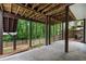 Covered patio area with view of fenced yard and mature trees, offering a relaxing outdoor retreat at 4442 Freeman Rd, Marietta, GA 30062