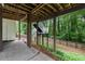 Covered patio and backyard area with stairs leading up to outdoor space at 4442 Freeman Rd, Marietta, GA 30062