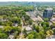 Expansive aerial shot capturing the home's location amidst a vibrant urban landscape with lush trees at 104 Terrace Ne Dr # 1, Atlanta, GA 30305