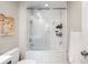 Bathroom featuring a tiled tub-shower combo with glass doors, and a built-in shelf at 104 Terrace Ne Dr # 1, Atlanta, GA 30305
