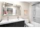 Bathroom featuring double sinks, modern cabinets, large mirror, and a tiled tub-shower combo at 104 Terrace Ne Dr # 1, Atlanta, GA 30305