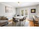 Elegant dining room features a modern table, stylish seating, and french doors for great natural light at 104 Terrace Ne Dr # 1, Atlanta, GA 30305