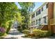 Lovely townhome with a private entrance framed by lush greenery and mature trees along a private drive at 104 Terrace Ne Dr # 1, Atlanta, GA 30305
