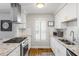 Kitchen with stainless steel appliances, gas range, granite countertops, and white cabinets at 104 Terrace Ne Dr # 1, Atlanta, GA 30305