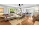 Open living room and dining room featuring a hardwood floor, large windows, and a comfortable layout at 104 Terrace Ne Dr # 1, Atlanta, GA 30305