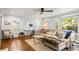 Bright living room showcasing a hardwood floor, neutral color palette, and large windows with plantation shutters at 104 Terrace Ne Dr # 1, Atlanta, GA 30305