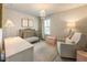 Charming Bedroom with white walls, chandelier, crib, accent chair, and natural light at 120 Maple Creek Way, Woodstock, GA 30188