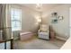 Bright Bedroom featuring a crib, reading chair, shelves, lamp and natural light at 120 Maple Creek Way, Woodstock, GA 30188