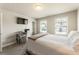 Bright bedroom features a dedicated workspace, two windows, and neutral walls at 120 Maple Creek Way, Woodstock, GA 30188