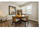 Cozy dining room with natural light, hardwood floors, view of the kitchen, and modern lighting at 120 Maple Creek Way, Woodstock, GA 30188