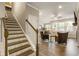 Inviting entryway with staircase leading to the upper level, hardwood floors and a view to the living area at 120 Maple Creek Way, Woodstock, GA 30188