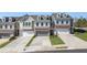 Exterior view of charming townhomes with garages and landscaped front yards at 120 Maple Creek Way, Woodstock, GA 30188