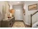Inviting foyer with wood floors, stylish decor, and staircase at 120 Maple Creek Way, Woodstock, GA 30188
