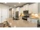 Bright, open kitchen with stainless steel appliances, center island with seating and white cabinets at 120 Maple Creek Way, Woodstock, GA 30188