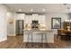 Bright kitchen with stainless steel appliances and center island with seating that opens to a dining area at 120 Maple Creek Way, Woodstock, GA 30188