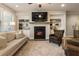 Open-concept living space with a fireplace, dining area, and large windows at 120 Maple Creek Way, Woodstock, GA 30188