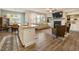 Bright living room featuring hardwood floors, fireplace, built-in bookcases, and open concept kitchen with island at 120 Maple Creek Way, Woodstock, GA 30188