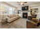 Spacious living room with a fireplace, built-in shelving, and natural light at 120 Maple Creek Way, Woodstock, GA 30188