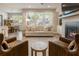 Stylish living room with large windows and open concept dining at 120 Maple Creek Way, Woodstock, GA 30188