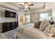 Serene main bedroom with a tray ceiling, soft lighting, and a view into an ensuite bathroom at 120 Maple Creek Way, Woodstock, GA 30188