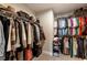 A well-organized walk-in closet with rods and shelves for clothing, bags, and shoes at 120 Maple Creek Way, Woodstock, GA 30188