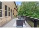 Charming back deck with wood railing offering ample seating, and picturesque tree views at 279 Sturry Dr, Mcdonough, GA 30252