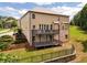 Charming backyard features a two-story deck, lush landscaping, and serene setting at 279 Sturry Dr, Mcdonough, GA 30252
