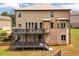 Spacious back exterior boasts a large two-story deck and a well-maintained lawn at 279 Sturry Dr, Mcdonough, GA 30252