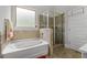 Bright bathroom with a separate tub and tiled shower at 279 Sturry Dr, Mcdonough, GA 30252
