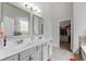Bathroom featuring double sinks, gray cabinets, and a walk-in closet at 279 Sturry Dr, Mcdonough, GA 30252