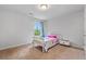 Comfortable bedroom boasts a white bed frame, neutral carpeting and a bright window at 279 Sturry Dr, Mcdonough, GA 30252