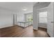 Open bedroom with wood floors and a playpen at 279 Sturry Dr, Mcdonough, GA 30252