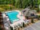 Aerial view of a community pool with lounge chairs and a slide, surrounded by trees at 279 Sturry Dr, Mcdonough, GA 30252