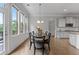 Dining area with a view, modern chandelier, and access to kitchen at 279 Sturry Dr, Mcdonough, GA 30252