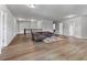 Open-concept living room featuring hardwood floors, a plush couch, and ample space at 279 Sturry Dr, Mcdonough, GA 30252