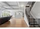 Open-concept space with hardwood floors, modern kitchen, and elegant staircase at 279 Sturry Dr, Mcdonough, GA 30252