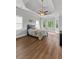 Spacious main bedroom featuring tray ceilings, large windows, and hardwood floors at 279 Sturry Dr, Mcdonough, GA 30252