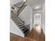 Bright foyer featuring staircase with black iron spindles and rich wood flooring at 279 Sturry Dr, Mcdonough, GA 30252