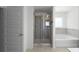 Bathroom with tile shower, soaking tub, tile floors, and lots of neutral light at 435 Noblewood Dr, Mcdonough, GA 30252