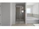 Bathroom featuring tile shower, soaking tub, tile floors, and neutral paint at 435 Noblewood Dr, Mcdonough, GA 30252