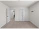 Bedroom featuring neutral carpet, double door closet, and an additional door way at 435 Noblewood Dr, Mcdonough, GA 30252