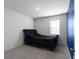 Comfortable bedroom with carpet and a bed with tufted navy headboard, illuminated by natural light from a window at 435 Noblewood Dr, Mcdonough, GA 30252