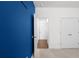 Neutral-toned bedroom with ample closet space, blue accent wall, and a doorway to the rest of the home at 435 Noblewood Dr, Mcdonough, GA 30252