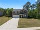 Charming two-story brick home features an attached two-car garage and a well-maintained front lawn at 435 Noblewood Dr, Mcdonough, GA 30252