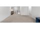 Bright hallway with neutral carpet, leading to multiple rooms, offering a sense of spaciousness and connectivity at 435 Noblewood Dr, Mcdonough, GA 30252
