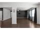 Spacious living room with hardwood floors, a dark accent wall, and open layout, perfect for relaxing and entertaining at 435 Noblewood Dr, Mcdonough, GA 30252
