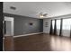 Spacious living room featuring hardwood floors, modern ceiling fan, and natural light from large windows at 435 Noblewood Dr, Mcdonough, GA 30252
