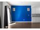 Bright living area with hardwood floors, a blue accent wall, and a sliding glass door, providing natural light at 435 Noblewood Dr, Mcdonough, GA 30252
