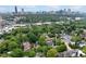Overhead view of a neighborhood with mature trees and a distant city skyline with the listing pointed out at 798 Saint Charles Ne Ave # 7, Atlanta, GA 30306