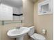Clean bathroom featuring a pedestal sink, modern toilet, a glass shelf, and window at 798 Saint Charles Ne Ave # 7, Atlanta, GA 30306